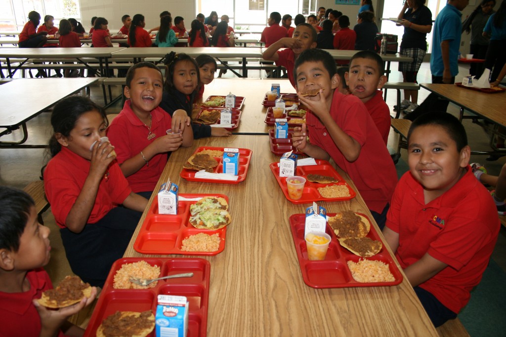Second-graders at the Academies of RCMA in Wimauma, Fla., enjoy a favorite for lunch: tostadas. It's the little things that help school leaders forge bonds with the children and their parents. 