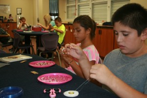 Students, most of whom are from the Seminole Indian Tribe, learn to string beads into jewelry the same way their ancestors did.