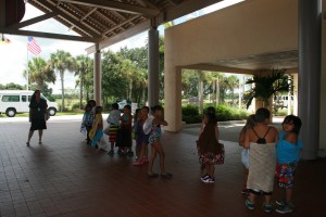 Students line up to ride the bus to the reservation's swimming pool.
