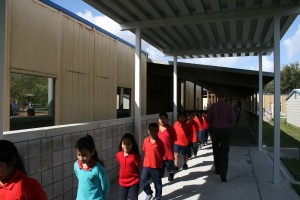 Students head to lunch at the Academies of RCMA charter school. The school tries to be creative when it comes to addressing the needs of its mostly Hispanic population. Some teachers only speak Spanish to students. Others try to set examples that help show the children there's more beyond Wimauma and high school.