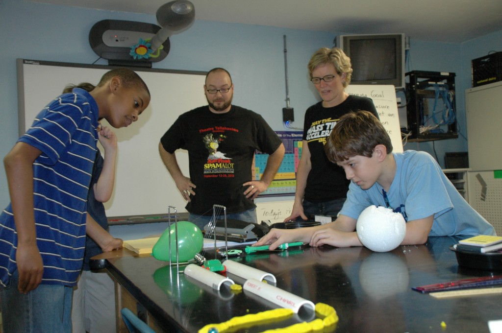 Teacher Julie Sear looks on as her students at The School of Arts and Sciences in Tallahassee, Fla. test out a Rube Goldberg contraption they created.